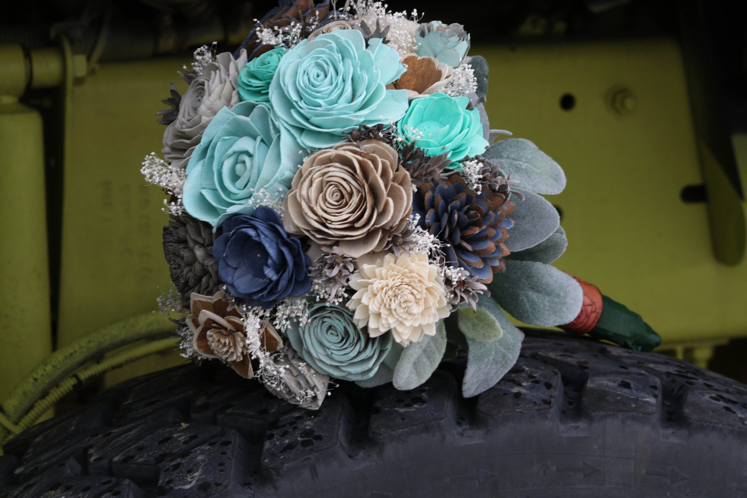 Showing wedding bouquet on engine tire